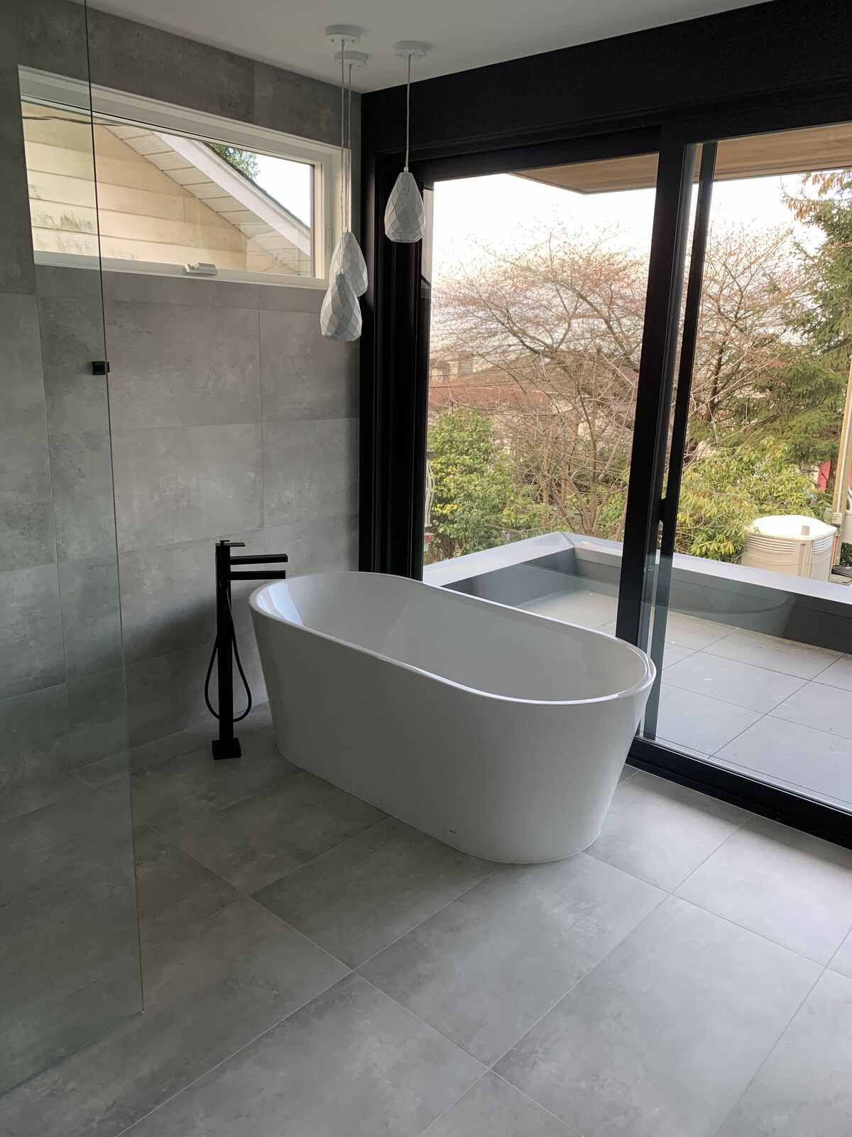 Ensuite with freestanding tub and large-format floor tile