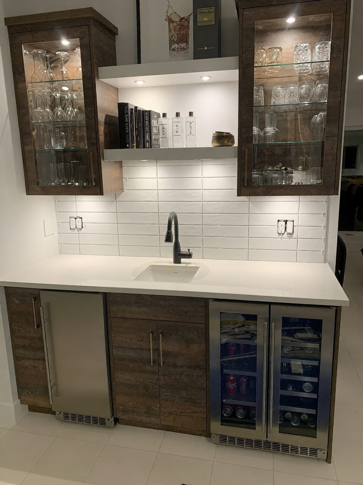 Bar area with a stacked tile backsplash and glass cabinets