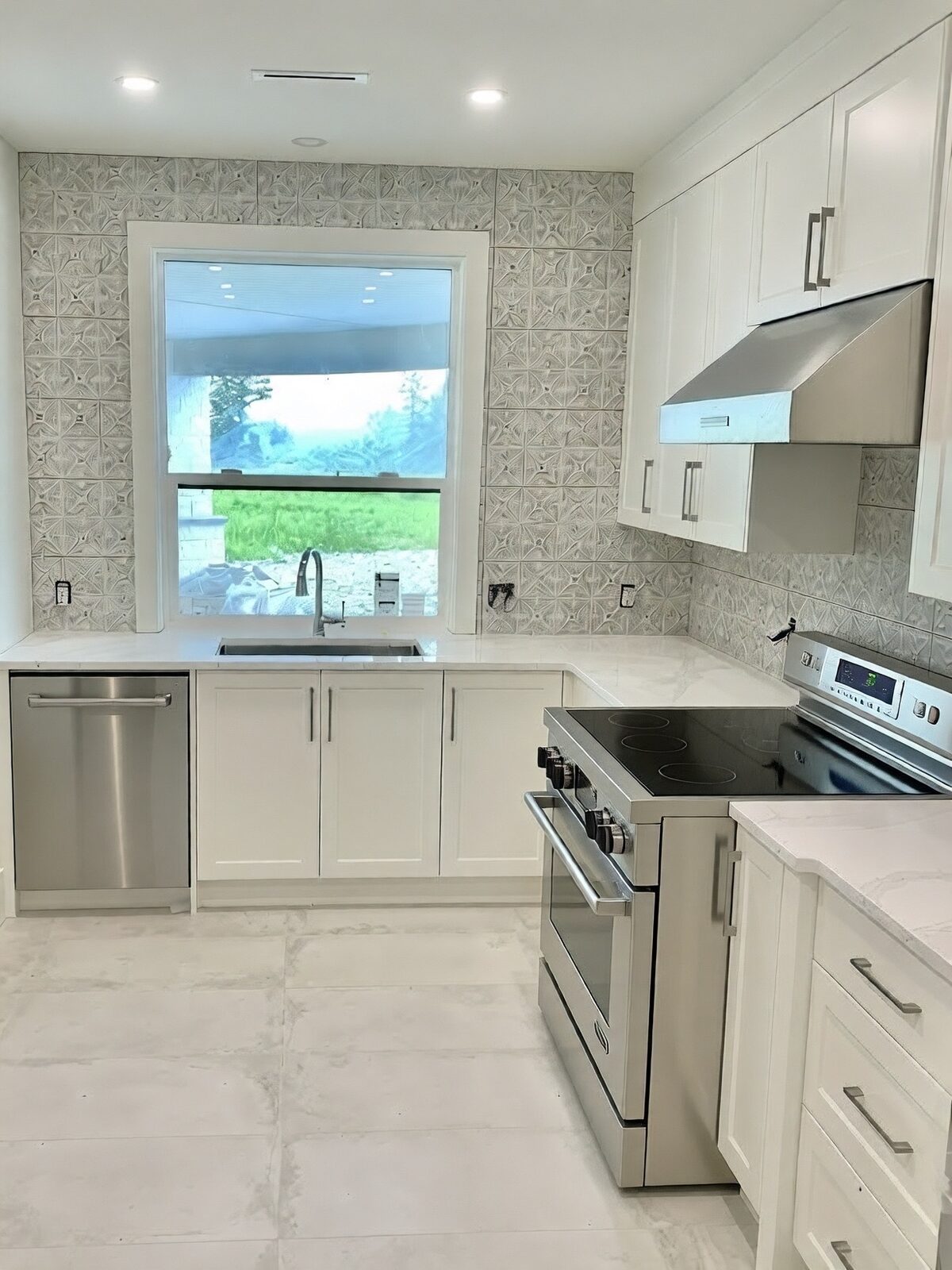 Kitchen backsplash running from the range wall to the window