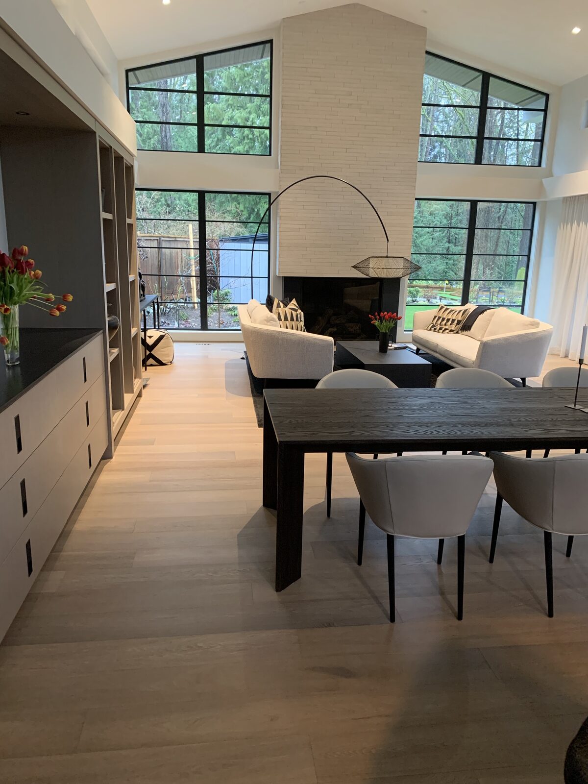 Wide-plank flooring through an open-plan dining and living area