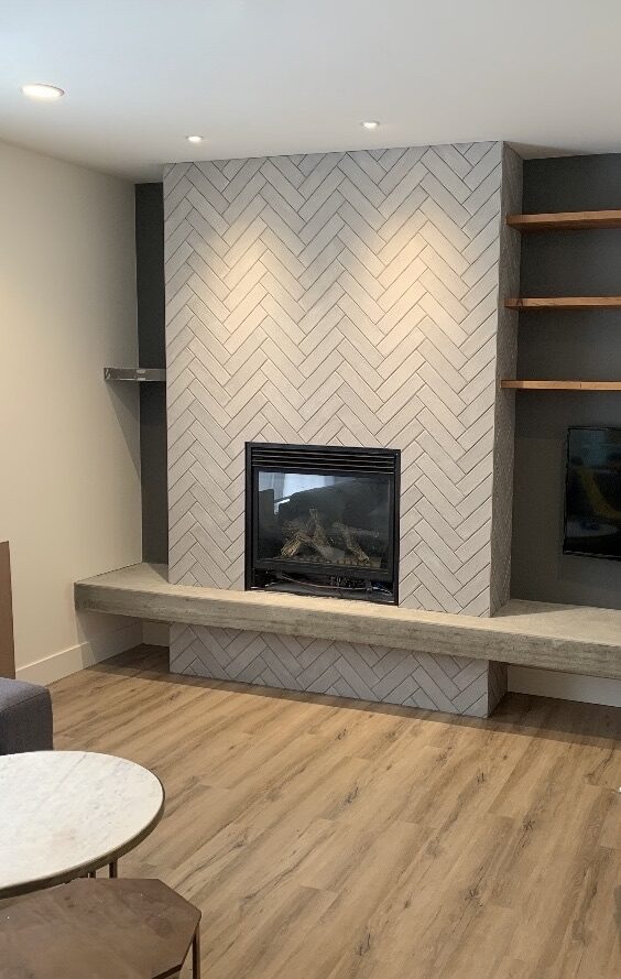 Herringbone tile fireplace wall with a bench hearth