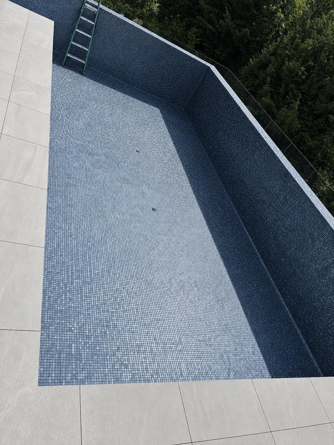Pool shell tiled in blue glass mosaic