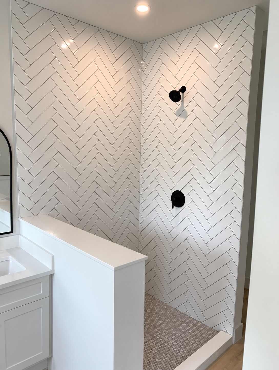 Walk-in shower in white herringbone tile